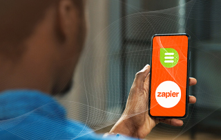 Unleash the Power of Your Digital Comms with Our New Zapier Integration_Everlytic Blog_Feature Image_Person Holding a Cell Phone with Image Symbolizing Zapier Integration