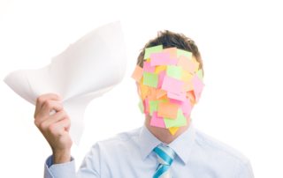 Businessman covered in stickers on white background