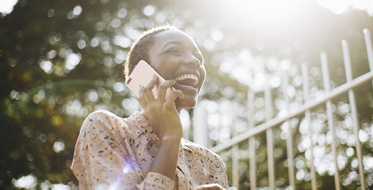 10 Reasons Why You Should Use Voice Broadcasting | Everlytic | Digital Communication Software | Email Marketing | Woman laughing on the phone | African woman on phone | Black woman on phone