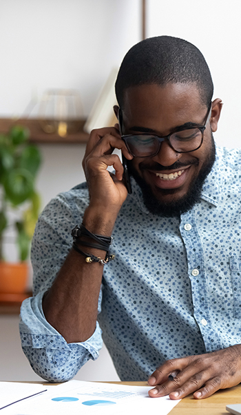 10 Reasons Why You Should Use Voice Broadcasting | Everlytic | Digital Communication Software | Email Marketing | Man on phone | African man on phone | African man smiling on phone