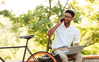 12 Tips to Create a Voice Broadcast | Everlytic | Digital communication software | Email marketing | Businessman working outside | Businessman with bicycle | Blog feature image