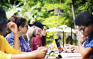 Digital Transformation & Student Engagement: Changing the Lives of South Africa’s Youth | Everlytic | Higher Education | Students around a table | Blog image | Students around a table | Blog feature image