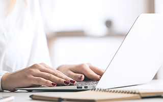Prepping Your Communication Tech Before a Crisis | Everlytic | Email Marketing | Blog feature image | Female hands on laptop