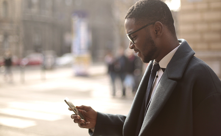 E0ODPV~0 Automate Communication by Tracking Customer Behaviour | Everlytic | Blog | Email Automation | African businessman on phone