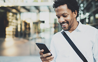 How to Use Contact Data for Automated Communications | Everlytic | Blog image | African man on mobile phone
