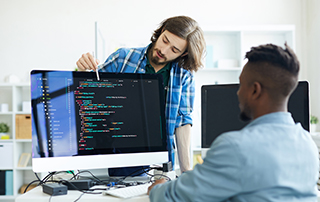 Automate Your Communications by Integrating with Other Systems | Everlytic | Blog feature image | Email Automation | Developers discussing code