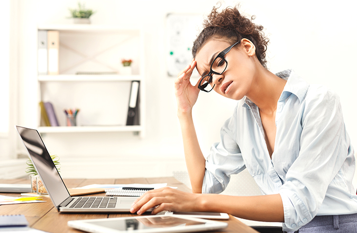 Everlytic-Blog-Spring-Clean-Your-Database-Blog-Image-2 Four Steps to Spring Clean Your Contact Database | Everlytic | Email Marketing | Blog | Woman stressed at her desk
