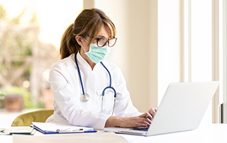Humanising Automated Medical Communication for Better Patient Relationships | Everlytic | doctor on a laptop