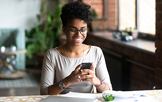Amplify Client Engagement with a Customer Experience Strategy | Everlytic | Blog feature image | Happy woman on cell phone