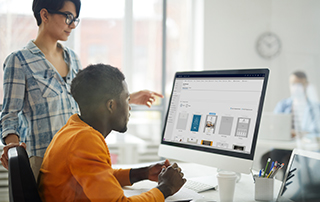 The Top 5 Ways to Use Everlytic’s Dynamics 365 Plugin | Businesspeople looking at desktop | Dynamics plugin | Everlytic | Blog post feature image
