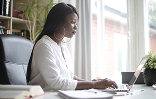 POPIA Q&A: Are There Loopholes to Data Privacy Laws? | Woman working on laptop | Feature image