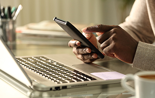 POPIA Q&A: What is Direct Marketing? | Everlytic | Defining direct marketing | Businessman at desk | Blog feature image