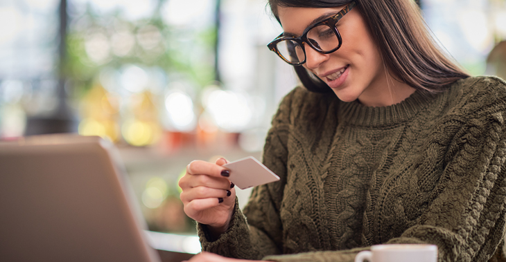 How to Segment Your eCommerce Email Lists in Everlytic | Everlytic Segmenting in Everlytic Blog Image2 Everlytic How to Segment Your eCommerce Email Lists in Everlytic | Lady looking at credit card in front of a laptop