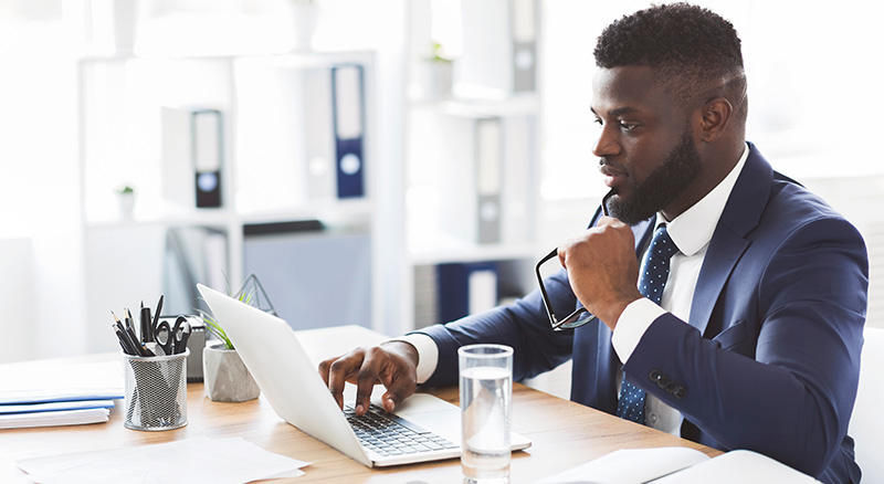 E1BX2H~Z Key Email Metrics & the Business Goals They Help You Achieve | Everlytic | Email marketing | Marketing automation | Businessman working at laptop