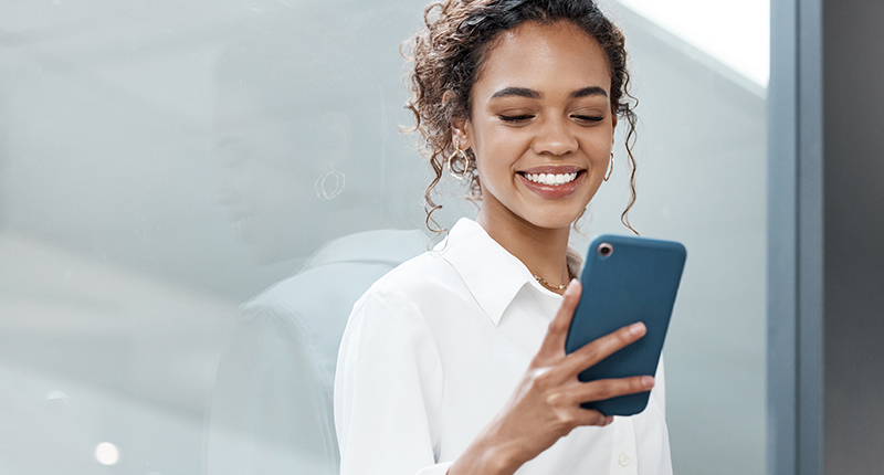 6 Subscription Form Best Practices for Effective Email Marketing | 3 Everlytic 2023 08 08 Subscription Form Blog Feature Everlytic 6 Subscription Form Best Practices for Effective Email Marketing_Everlytic Blog_Happy Woman Looking at Her Phone