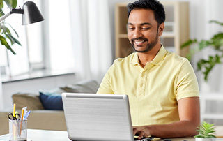 Master These 7 Bulk Email Types to Improve Subscriber Engagement | Everlytic | Bulk Communication | Feature Image | Man Reading Something Off Laptop