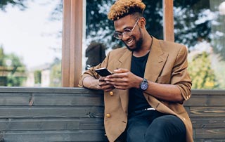 5 Powerful Tips for Crafting Engaging Transactional Email & SMS | Everlytic | Transactional Messaging | Man Reading Off a Cell Phone | Feature Image